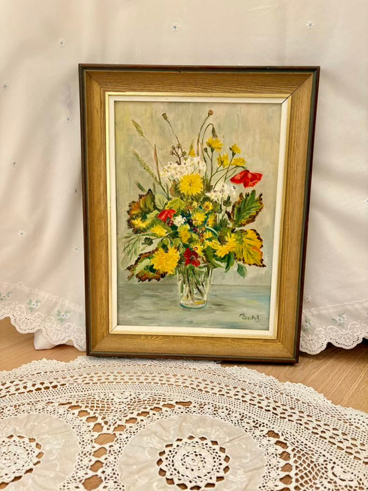 Framed painting of a floral arrangement on a lace tablecloth