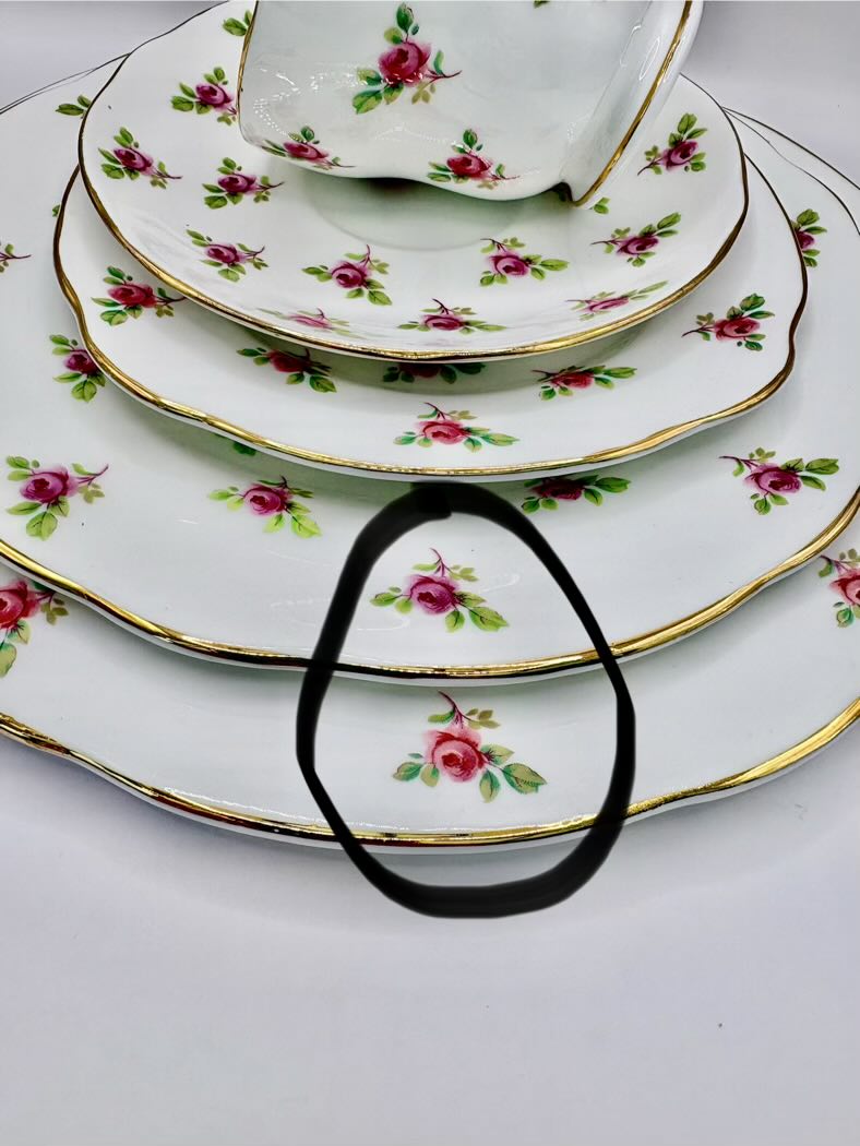 Set of floral-patterned plates stacked on a white surface