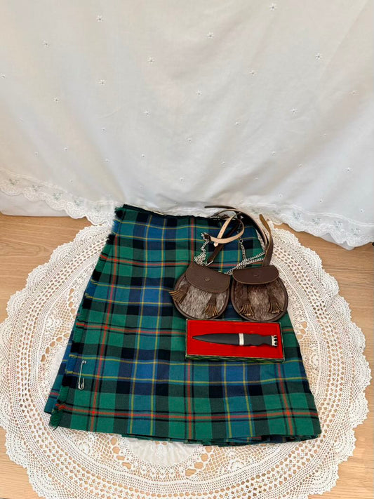 Plaid kilt with accessories on a lace doily
