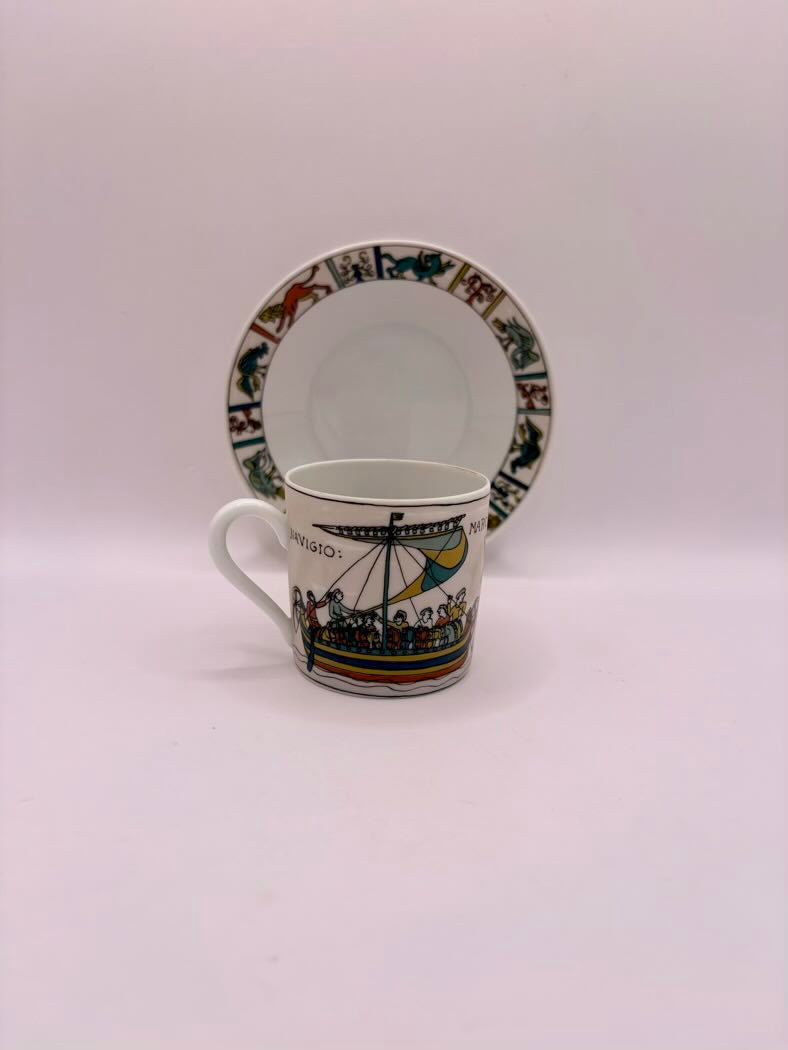 Ceramic mug and saucer with decorative patterns on a white background