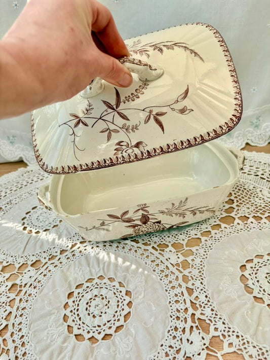Ceramic butter dish with lid on a lace tablecloth