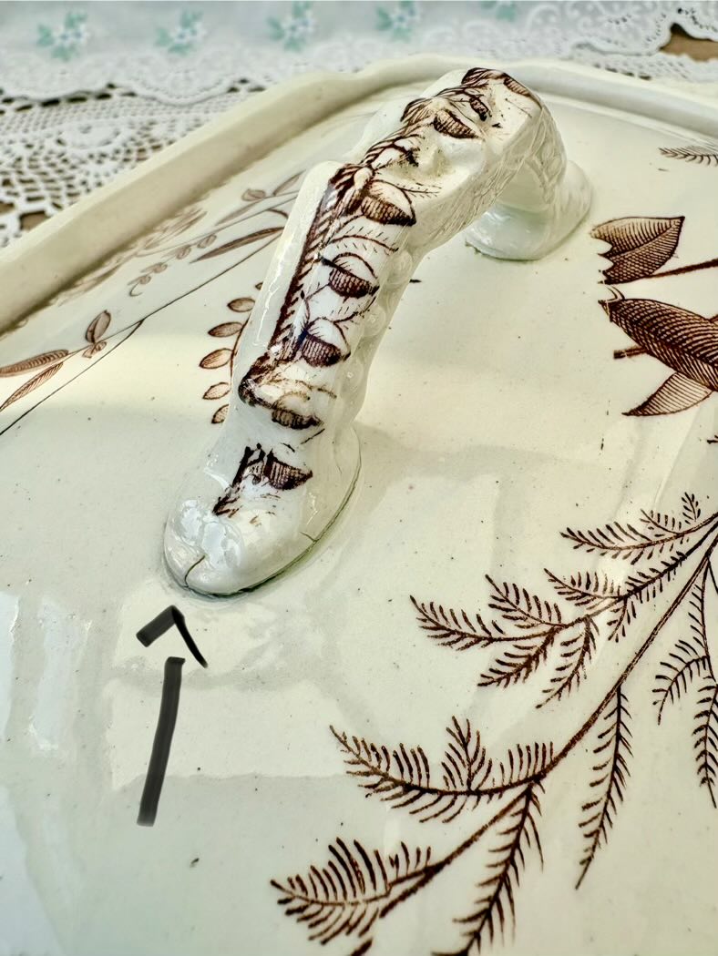 Decorative ceramic item with leaf patterns on a white background
