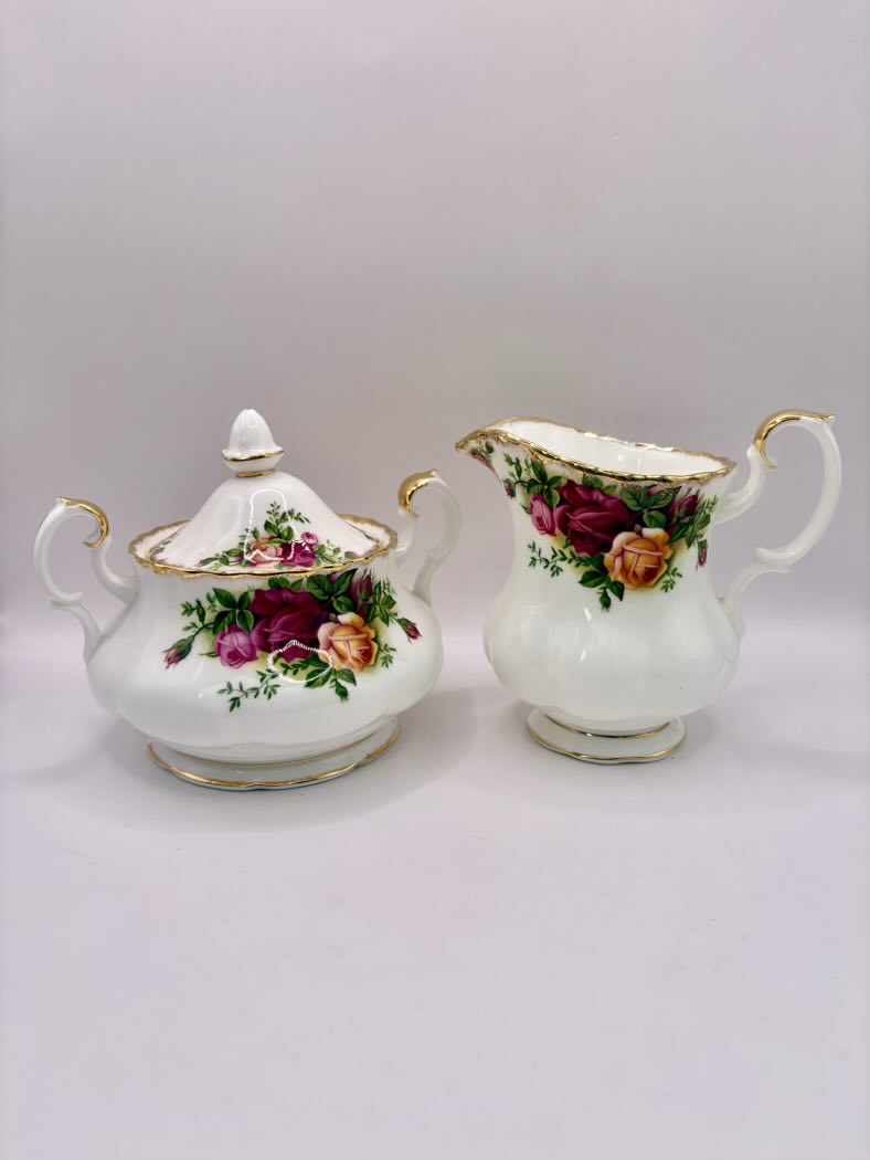 Tea set with floral design on a plain background