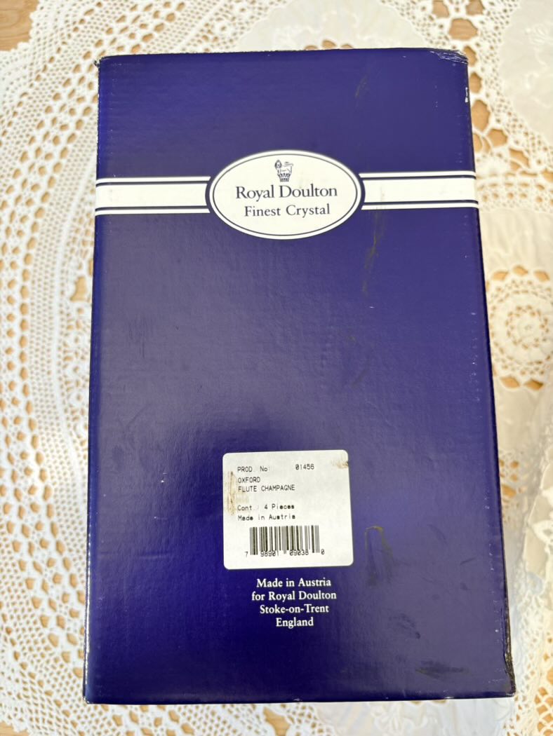 The original blue Royal Doulton Finest Crystal box with a label reading: Oxford Flute Champagne, 4 Pieces, Made in Austria