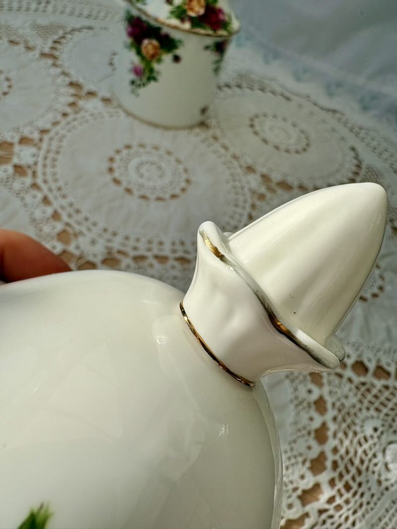 White ceramic container with a lid on a lace tablecloth