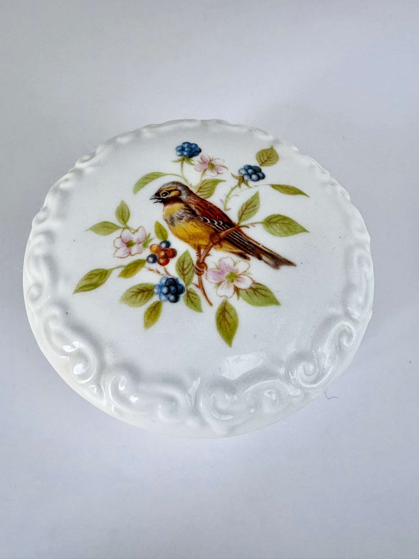 Porcelain trinket box with vintage bird design on lid, perfect for keepsakes