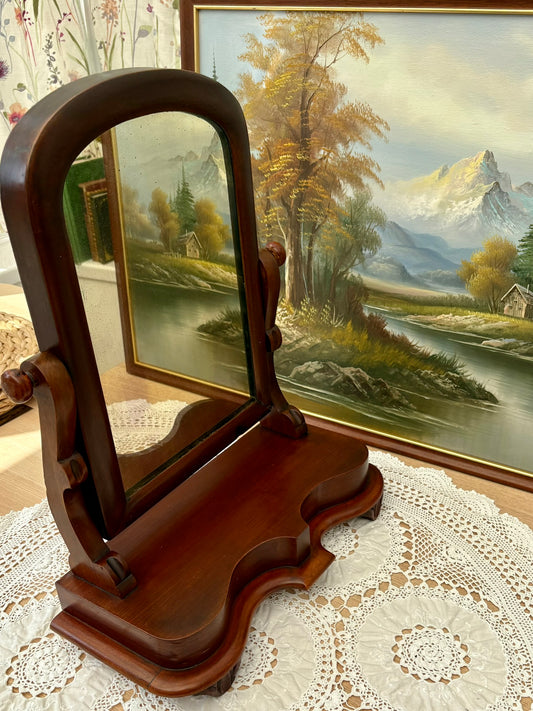 Side view of antique Victorian mahogany mirror showing scroll supports