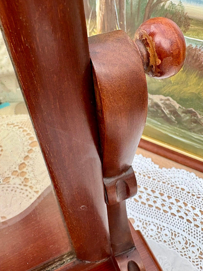 Close-up of original mirror plate with light foxing and mahogany frame