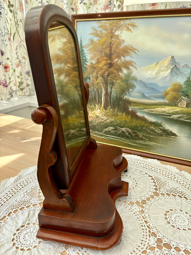 Side view of antique Victorian mahogany mirror showing scroll supports