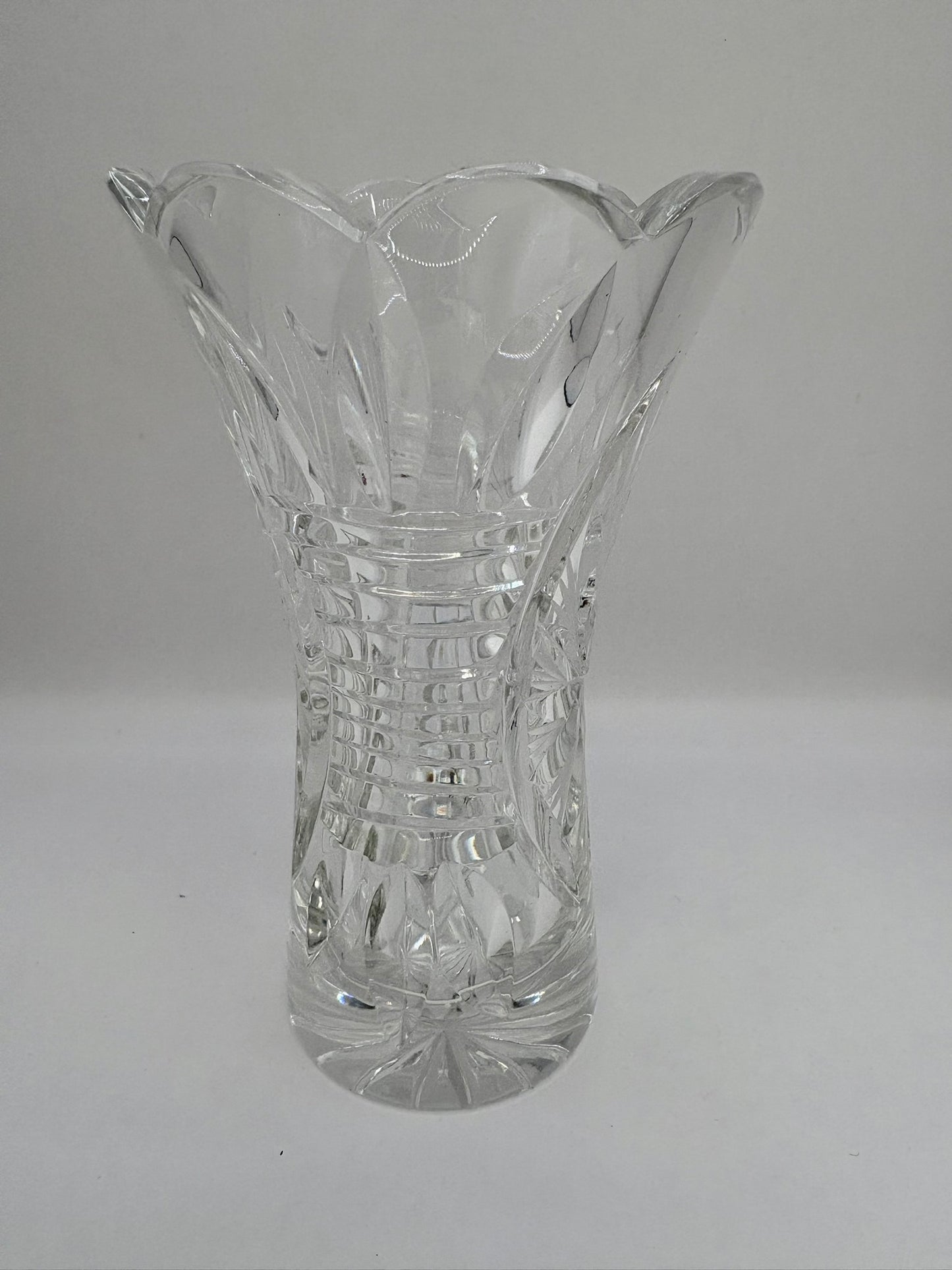 Clear glass vase with textured design on a gray background
