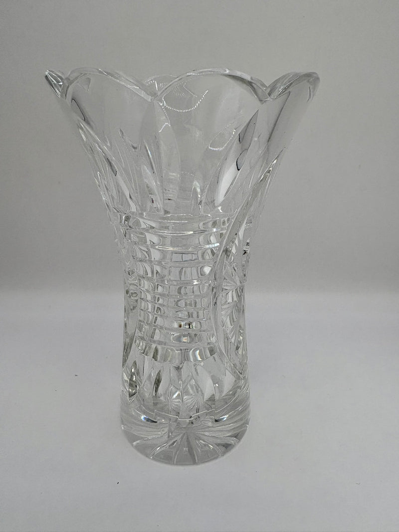 Clear glass vase with textured design on a gray background