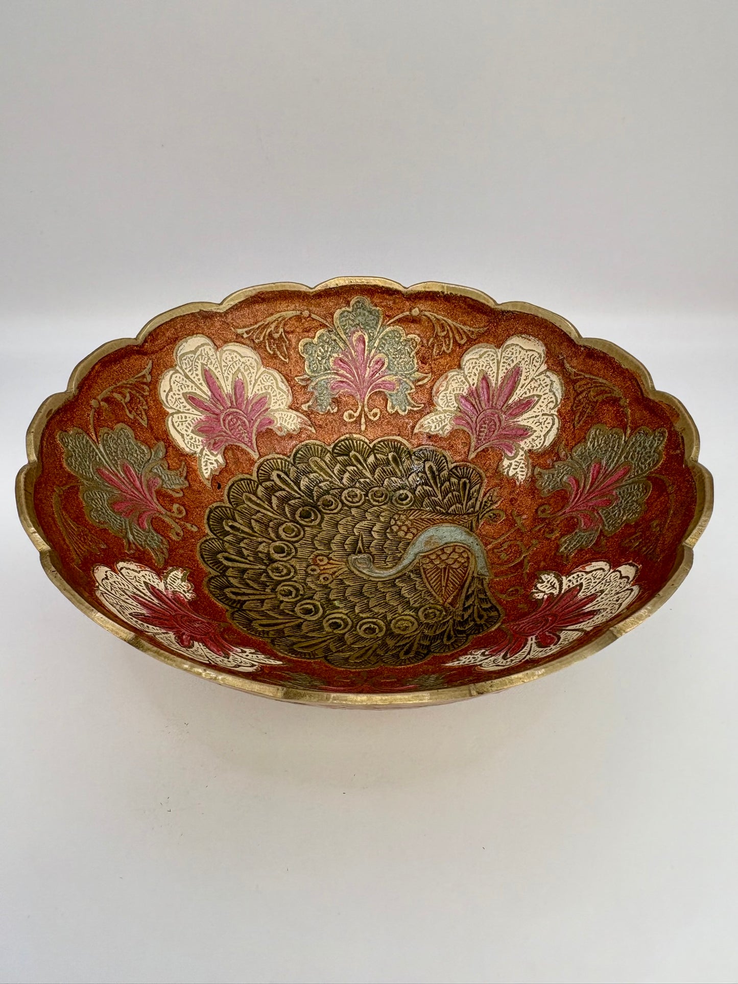 Decorative bowl with peacock design on a white background