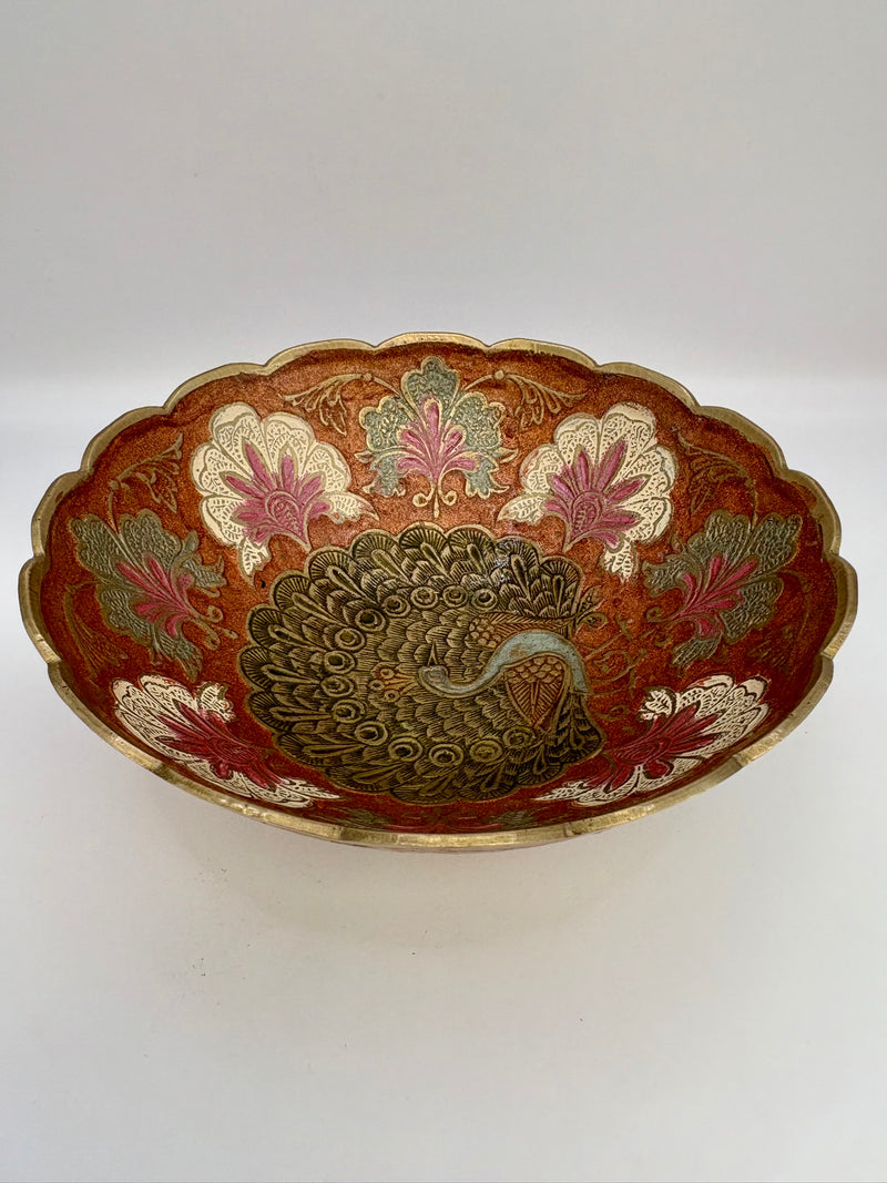 Decorative bowl with peacock design on a white background