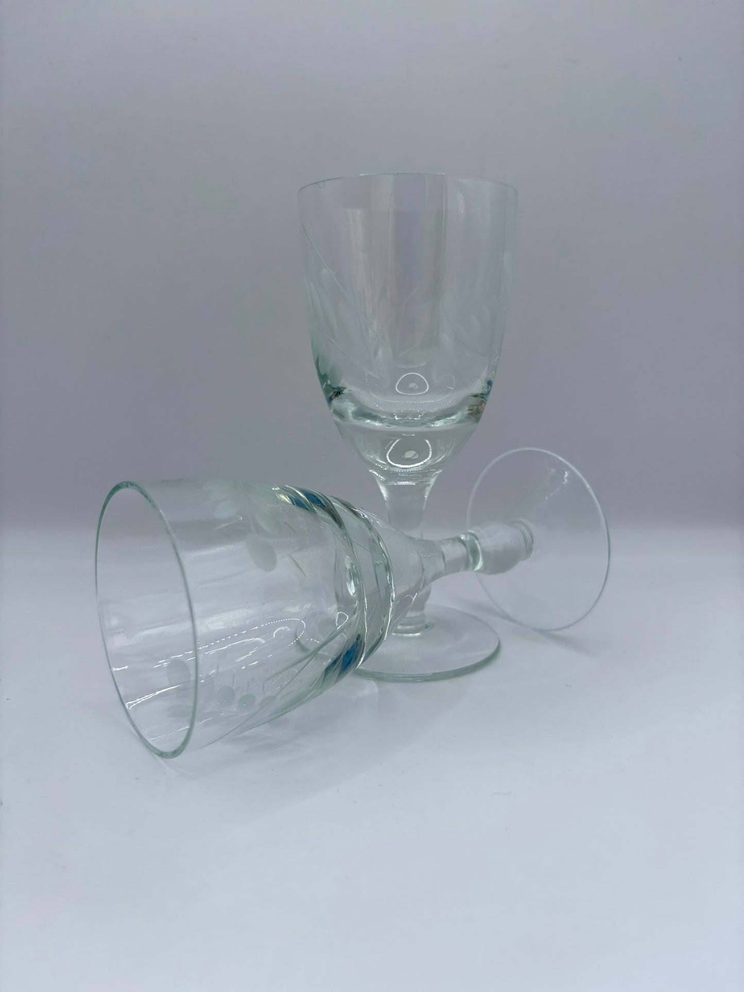 Two clear glass goblets on a white background