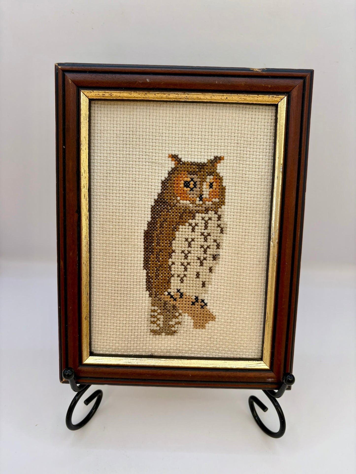 Framed cross-stitched owl on a white background