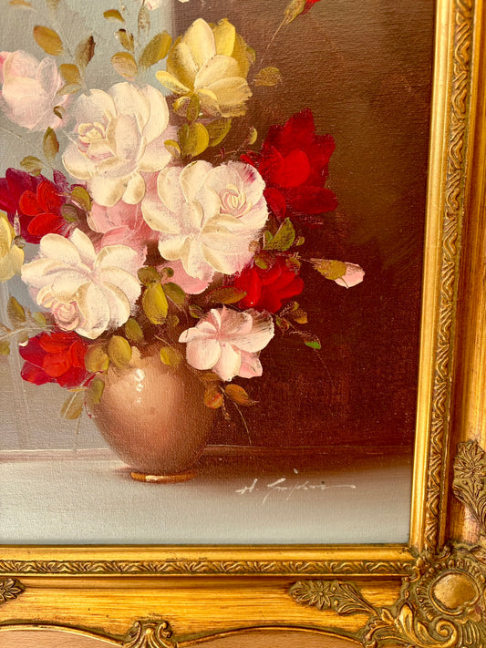 Floral arrangement in a vase with a gold frame