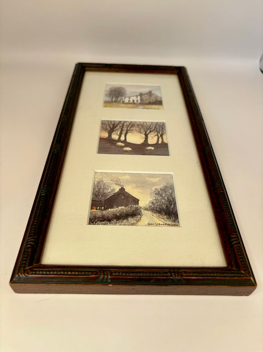 Framed set of three black and white photographs of landscapes.