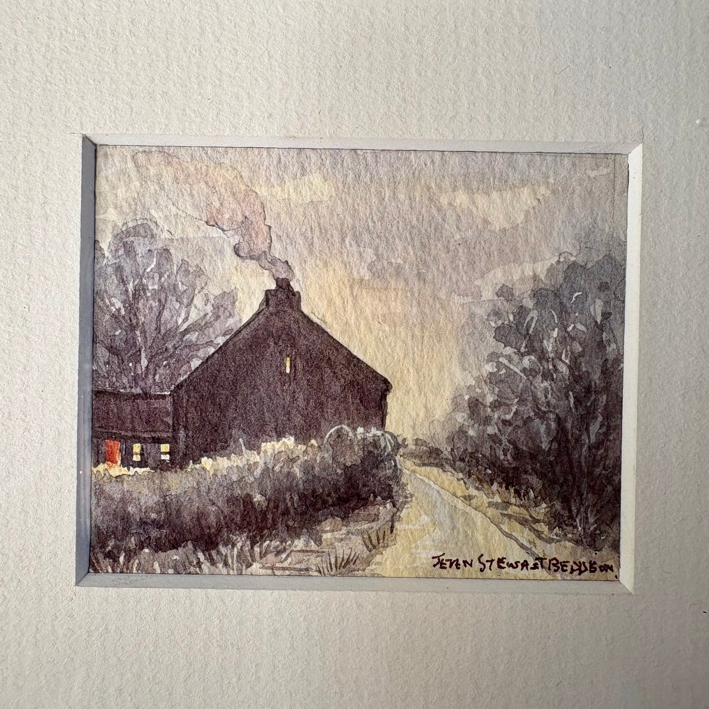 Framed painting of a barn with trees and a path on a textured wall.