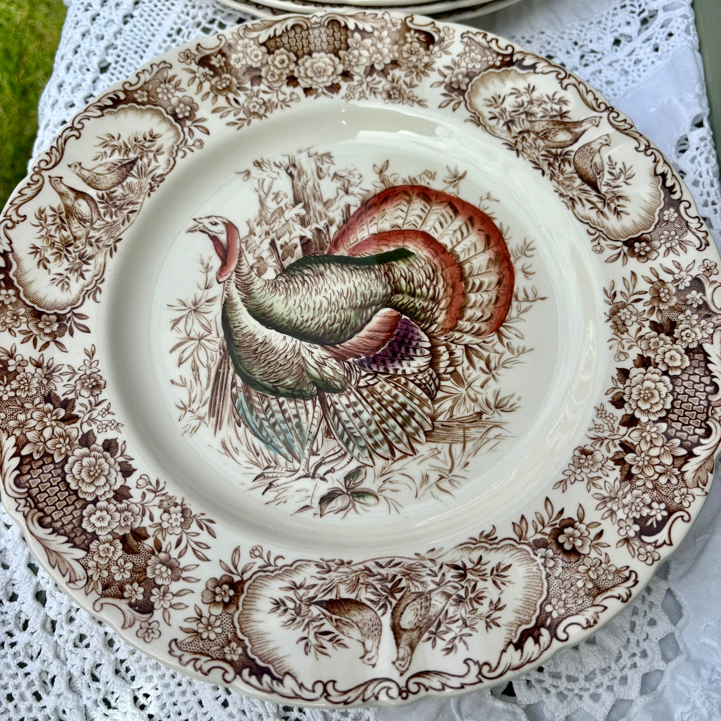 Decorative plate with a turkey design on a lace tablecloth