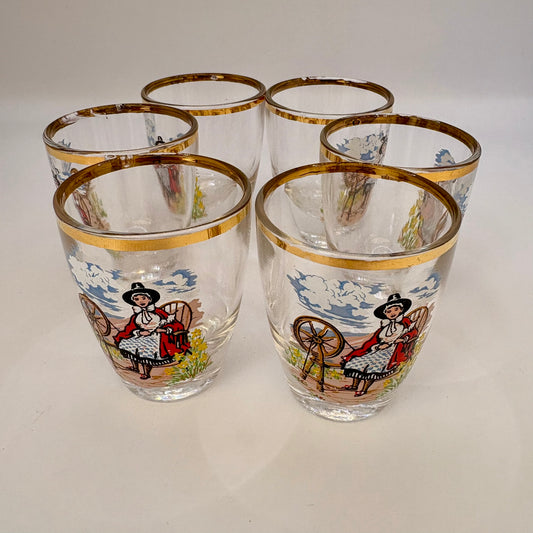 Set of six glass tumblers with decorative designs on a white background