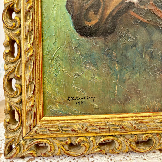 Close-up of a painting with a gold frame and signature, featuring a landscape scene.