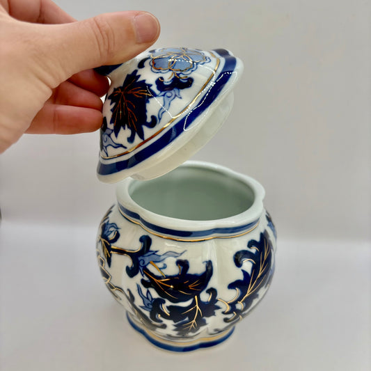 Ceramic jar with blue and white floral patterns on a plain background