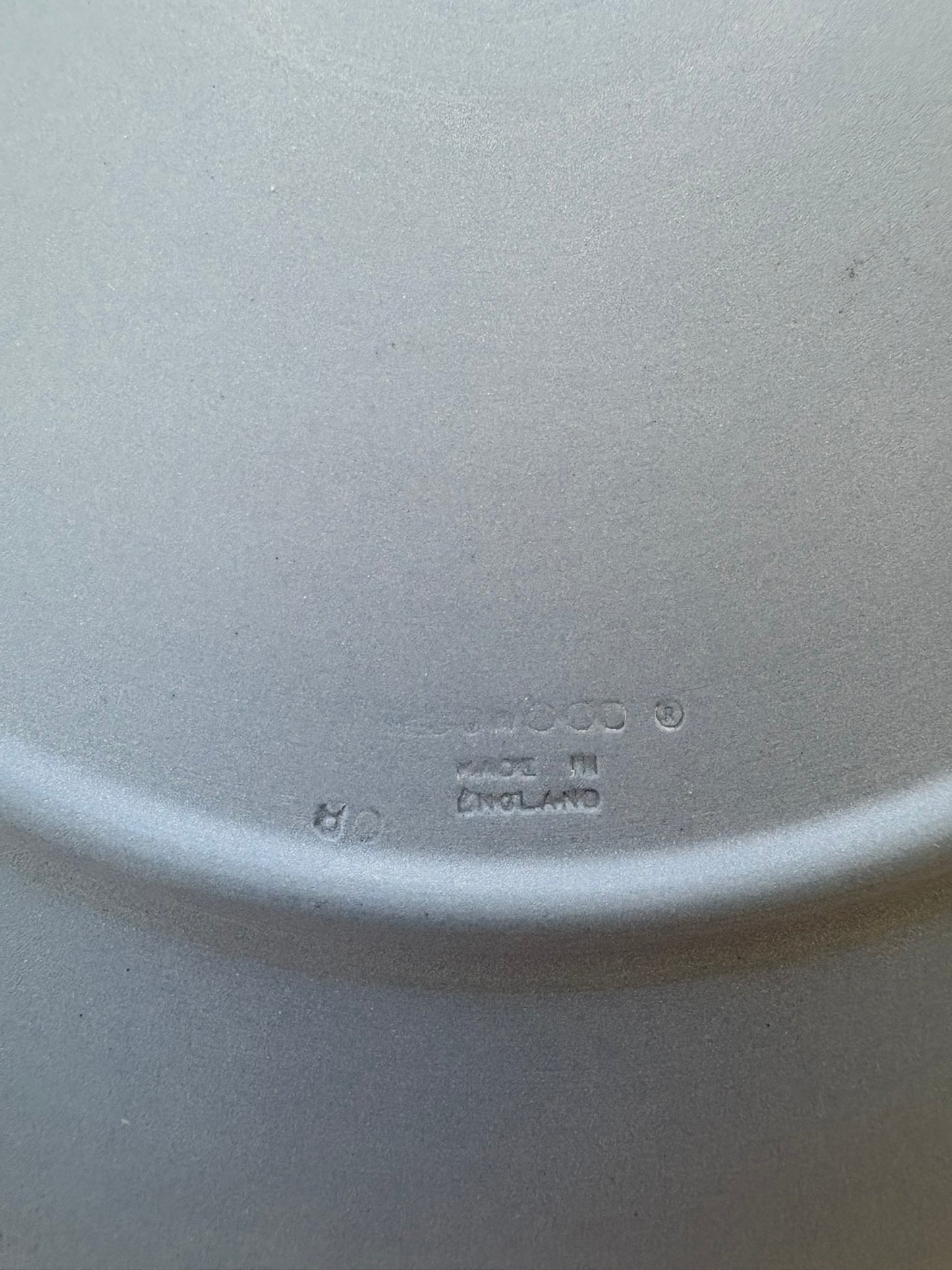 Close-up of a white ceramic plate with 'Ceramic' and 'Made in England' text.