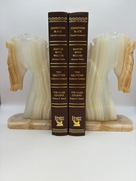 Two books titled 'Dances with Wolves' by Michael L. Frame, flanked by marble bookends on a white background.