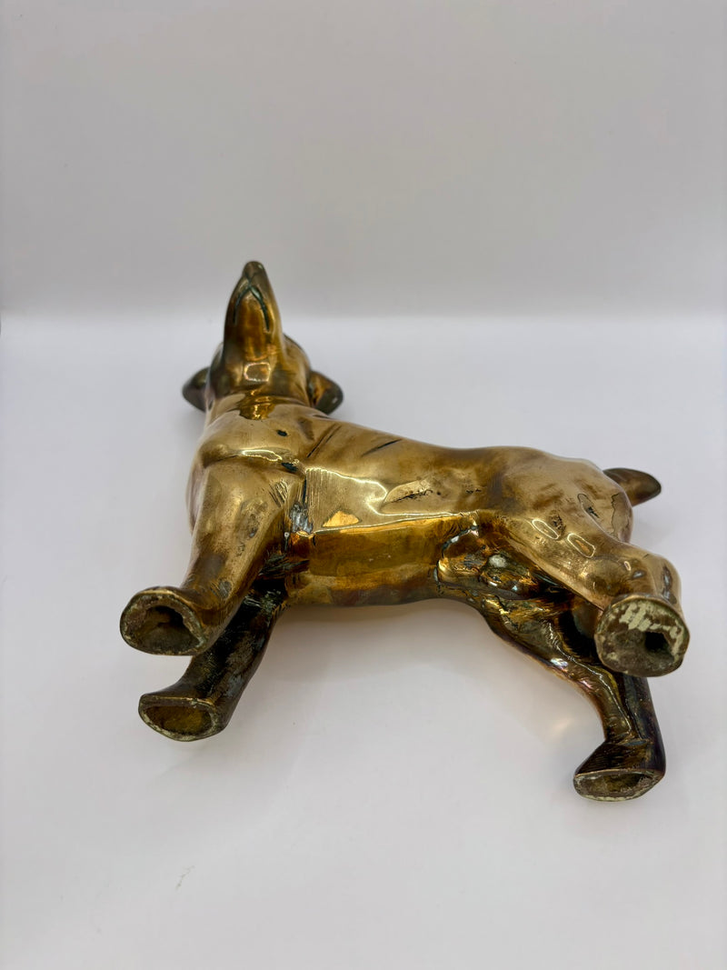 Brass dog figurine on a white background