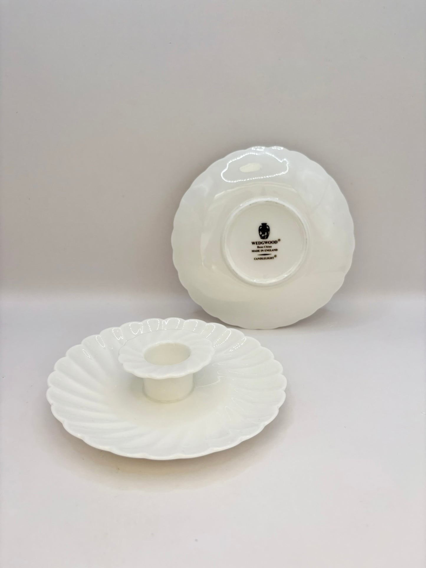 Two white ceramic items on a light gray background