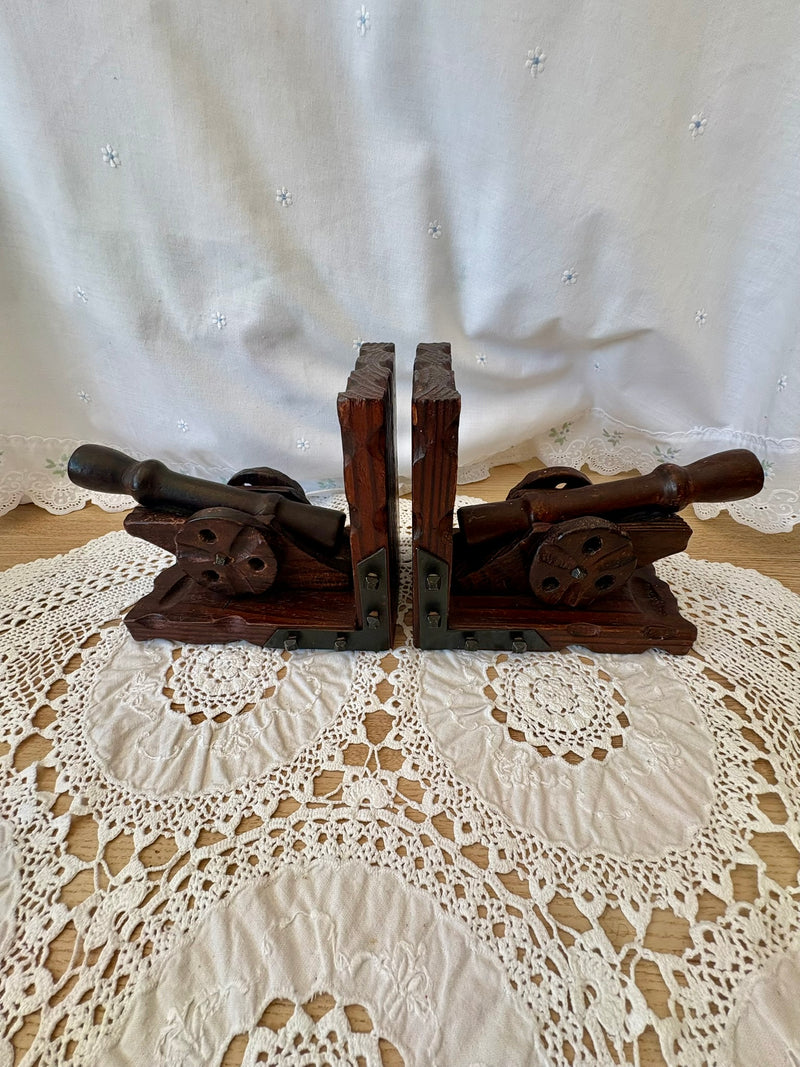 Wooden bookends with metal accents on a lace tablecloth
