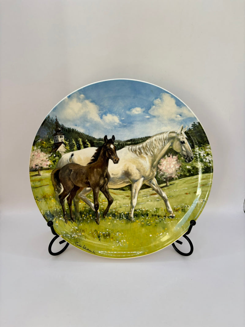 Decorative plate with horses in a field design on a white background