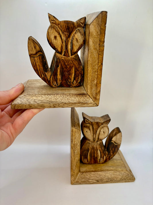 Wooden fox bookends on a white background