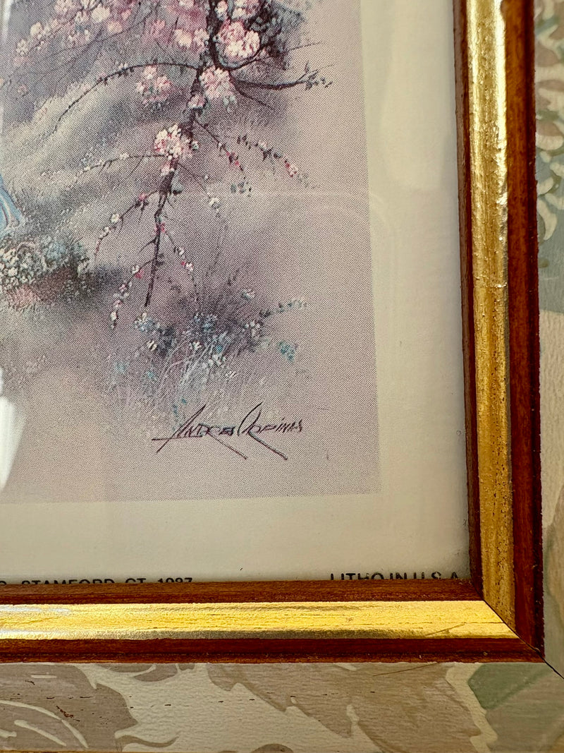 Framed artwork with a gold border featuring a floral design.