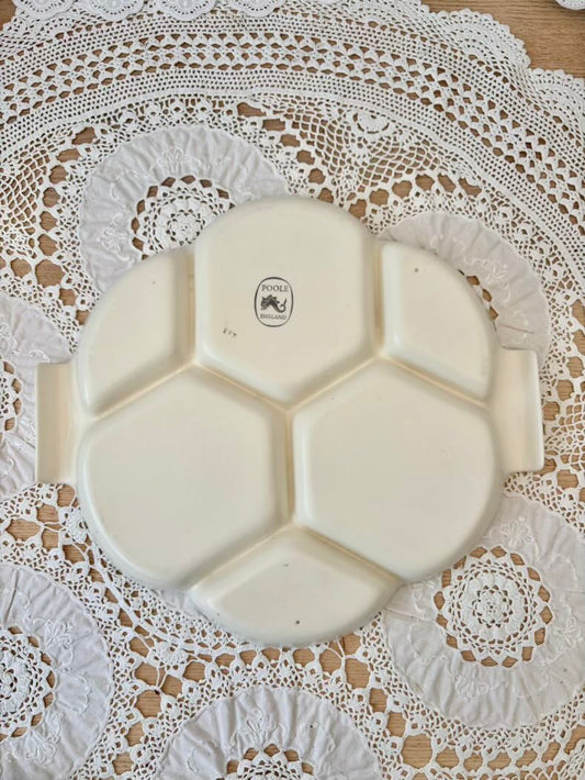White ceramic plate with hexagonal sections on a lace tablecloth