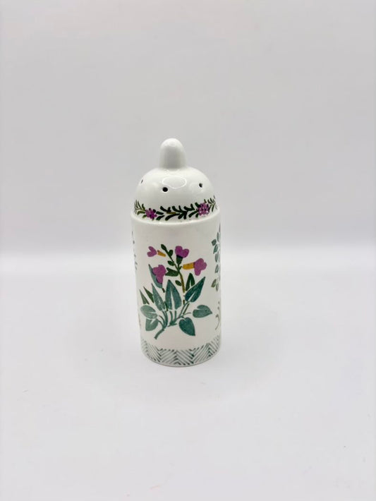 Ceramic jar with floral design on a white background