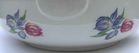 Ceramic dish with floral designs on a white background