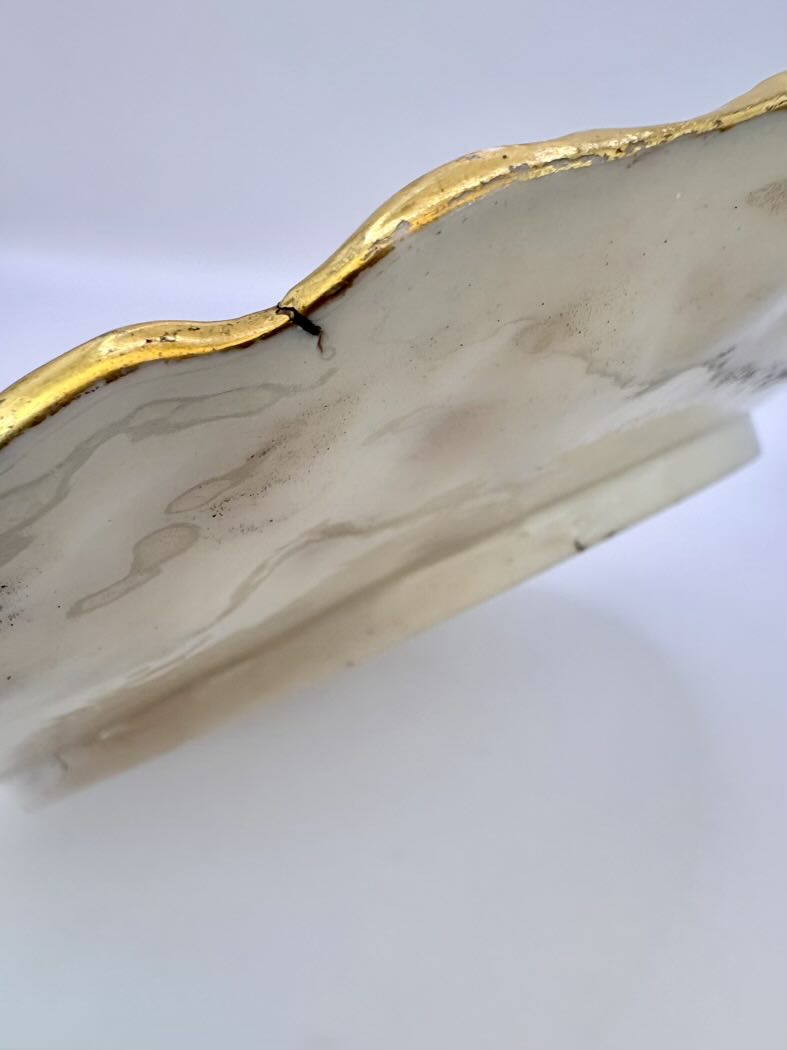 Marble-patterned object with gold edge on a white background