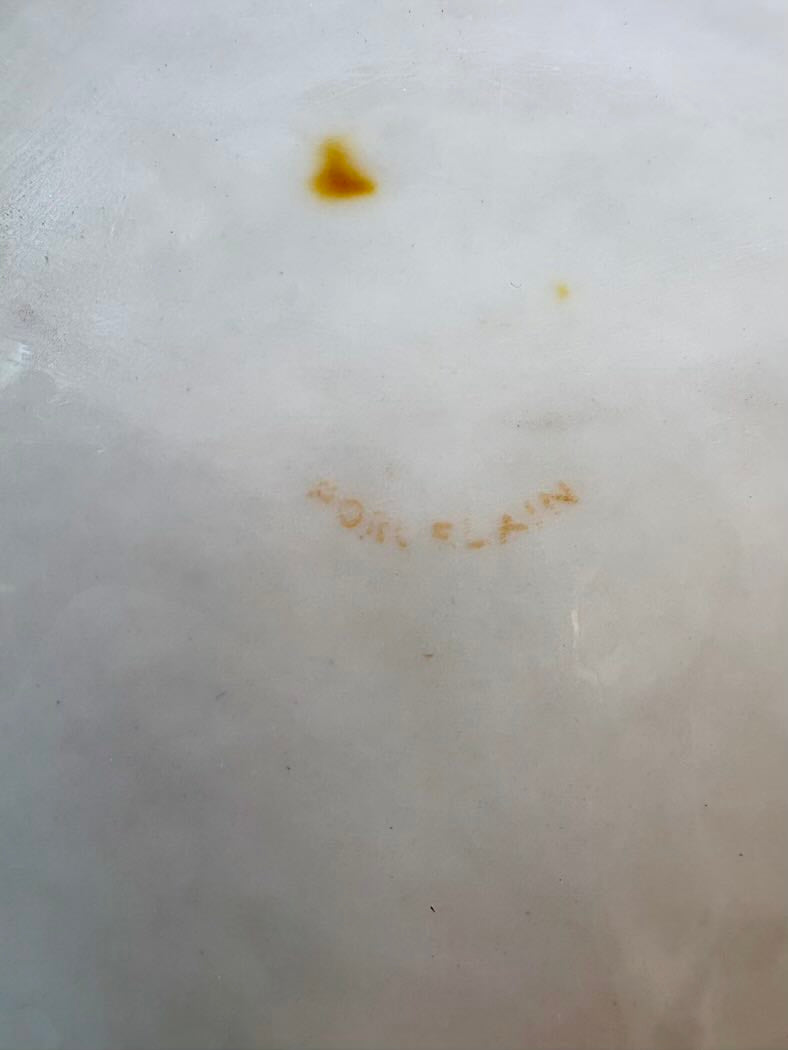 Close-up of a white surface with brown and yellow stains