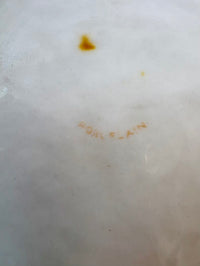 Close-up of a white surface with brown and yellow stains