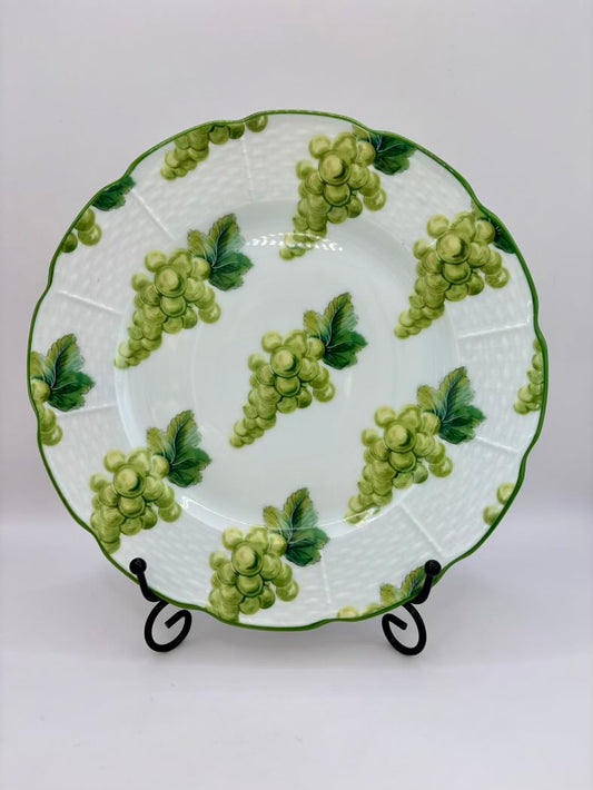 Ceramic plate with green grape design on a white background