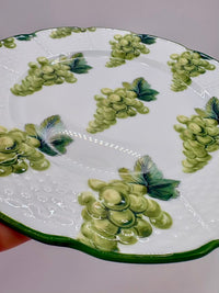 Decorative plate with green floral patterns on a white background