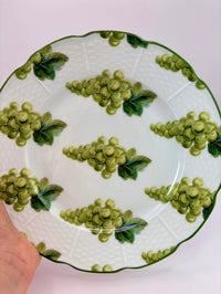 Ceramic plate with green grape design on a white background