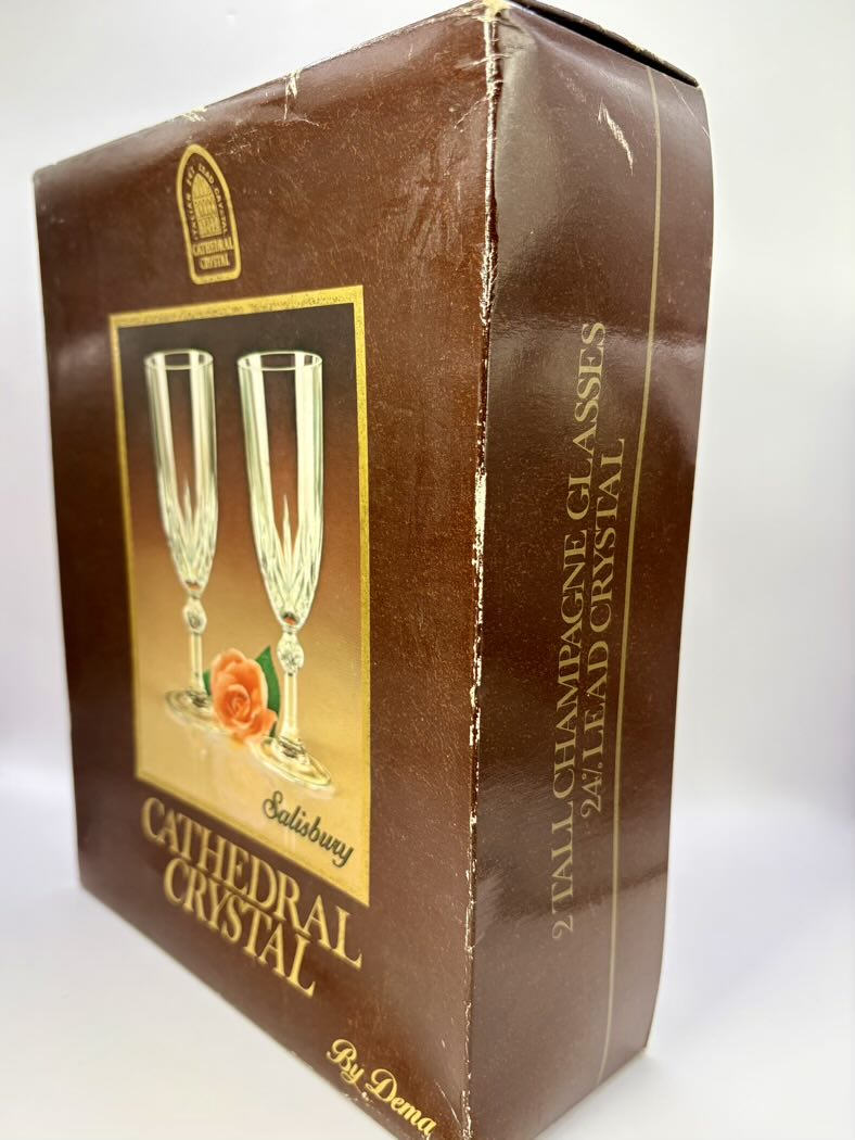 Box of Cathedral Crystal champagne glasses with a brown and gold design.
