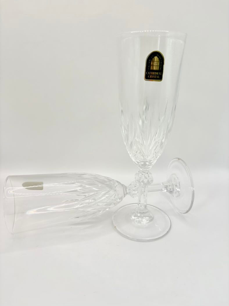 Clear glass flute with a brand logo on a white background