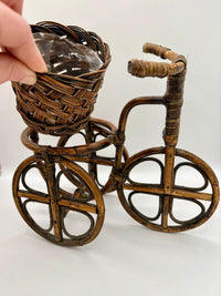 Wicker tricycle with a basket on a white background