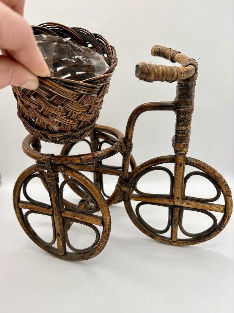 Wicker tricycle with a basket on a white background