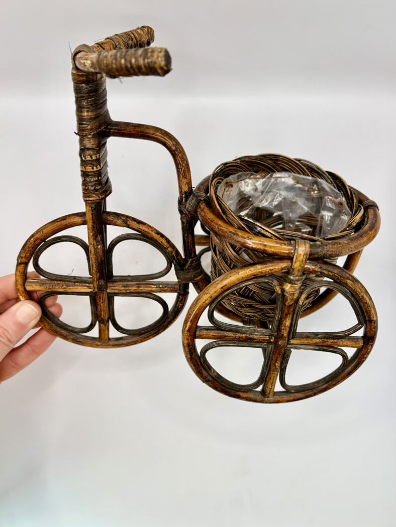 Decorative bicycle-shaped holder with a crystal on a white background