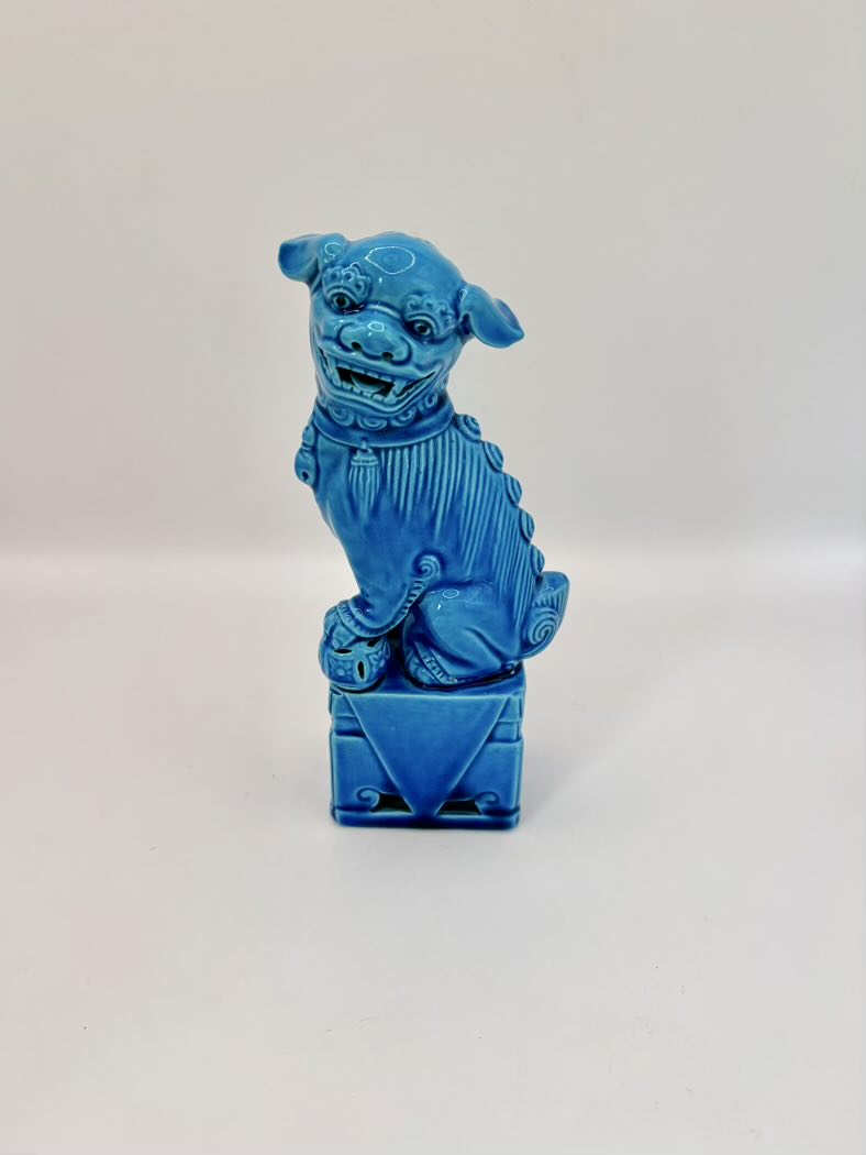 Blue ceramic dog figure on a white background