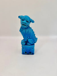 Blue ceramic dog figure on a white background